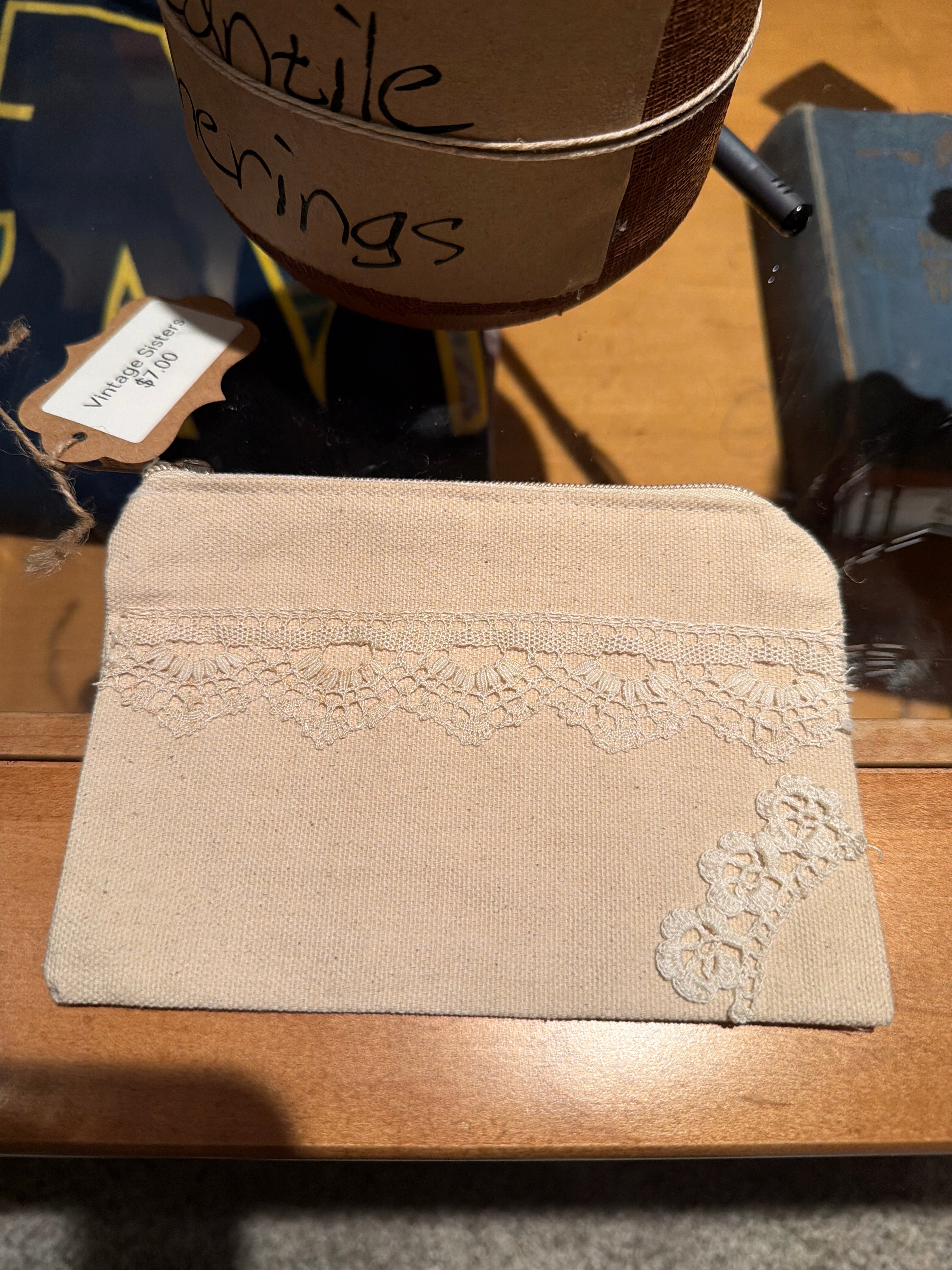 Small cosmetic bag with hand sewn doily decor
