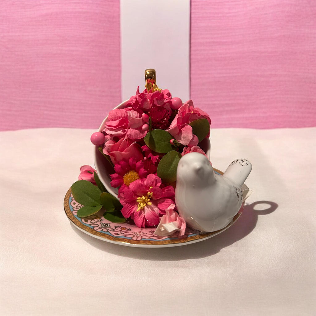 Pink teacup/saucer arrangement with white bird