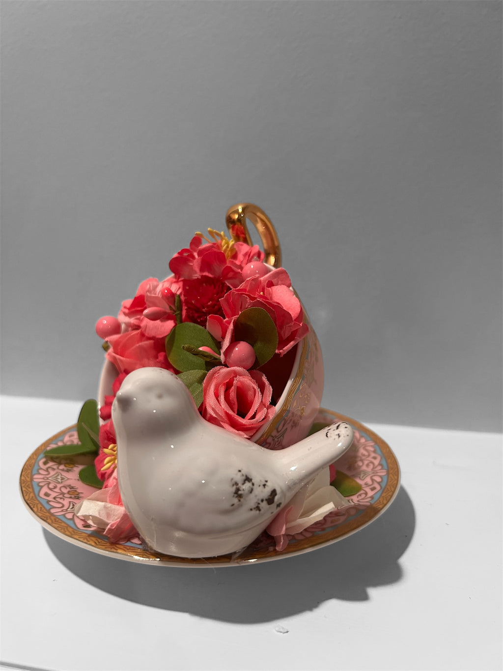 Pink teacup/saucer arrangement with white bird