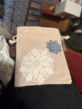 Small linen drawstring bag with hand sewn doily decor
