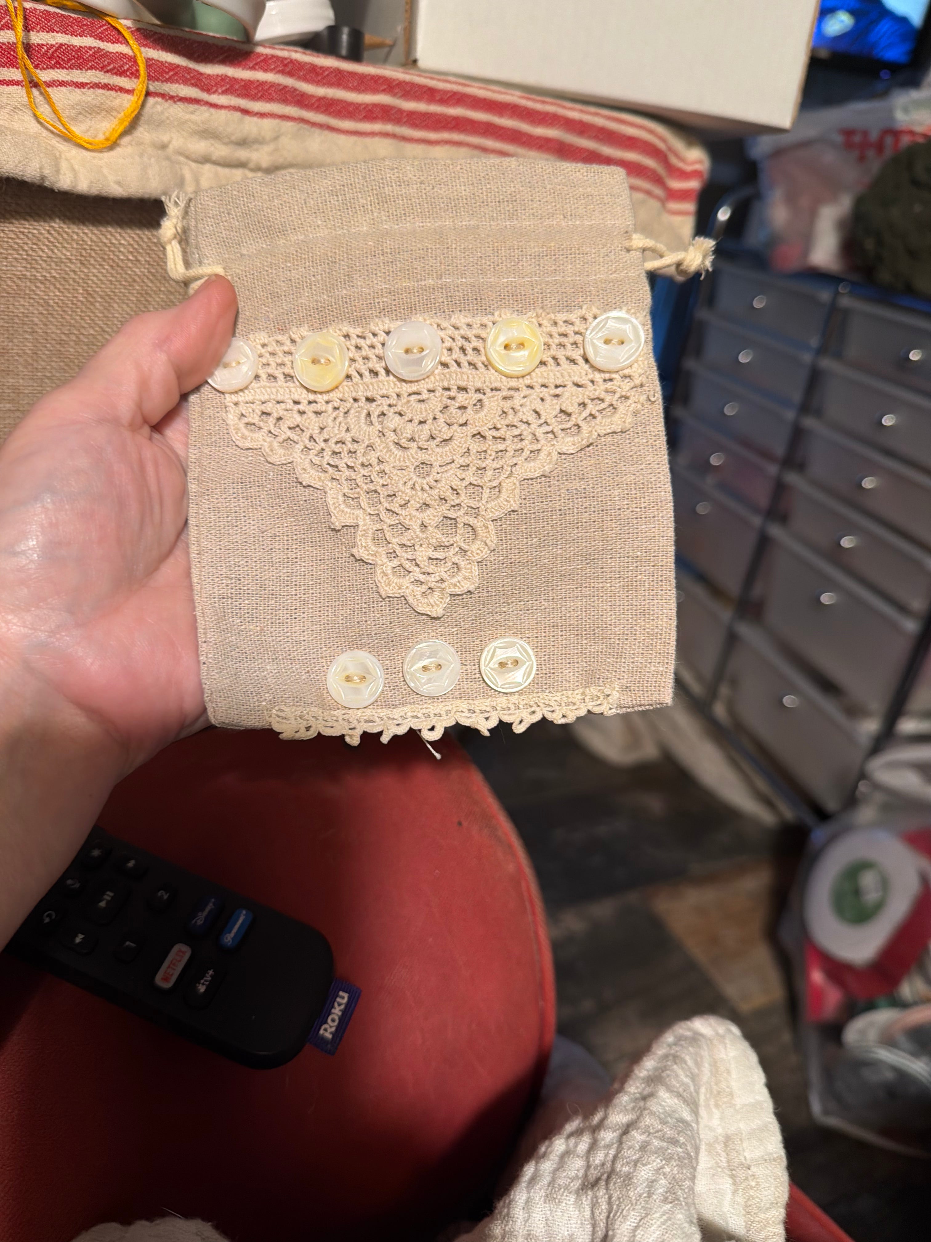 Small linen drawstring bag with hand sewn doily decor