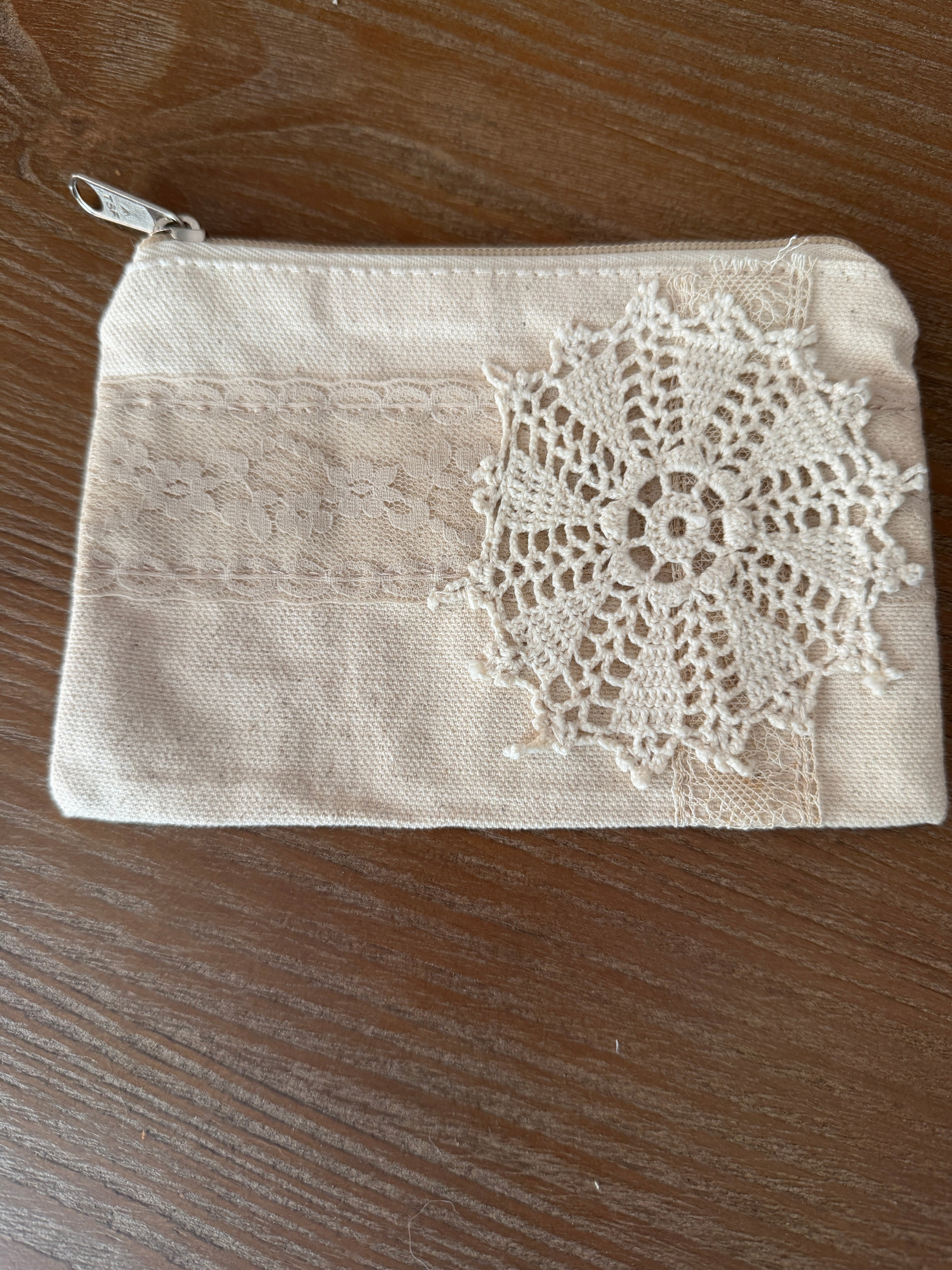 Small cosmetic bag with hand sewn doily decor both sides