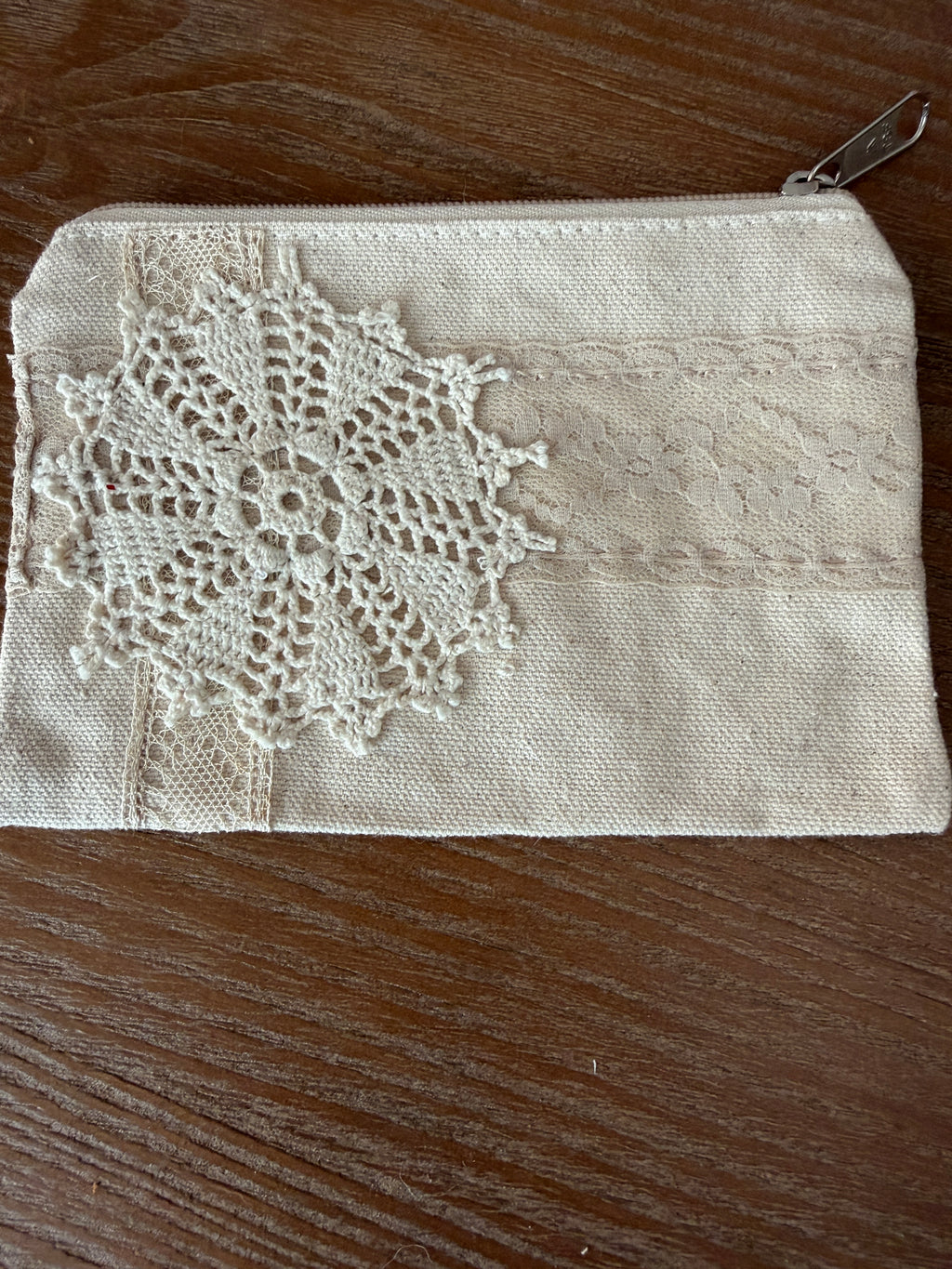 Small cosmetic bag with hand sewn doily decor both sides