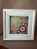 Embroidered garden design in white, square frame