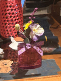 purple vase with purple flowers